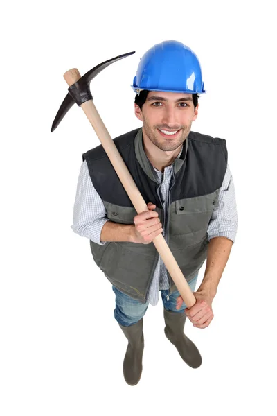 A manual worker with a pickaxe. — Stock Photo, Image