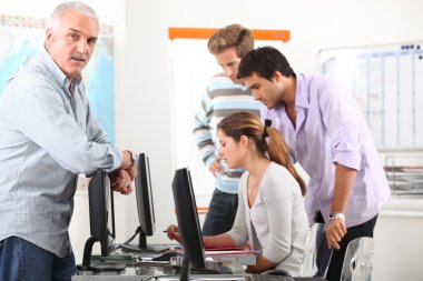 Manager and his team working at computers clipart