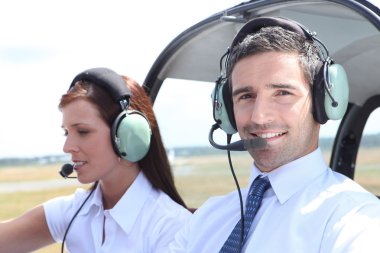 Man and woman in the cockpit of a light aircraft clipart