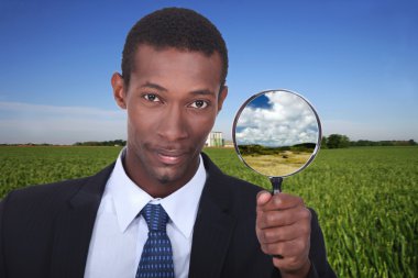 Businessman with magnifying glass clipart