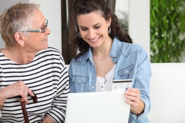 Mother and daughter shopping online clipart