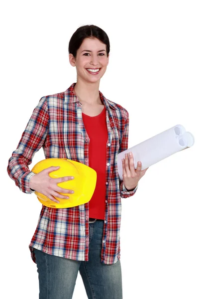 Craftswoman holding a helmet and a blueprint — Stock Photo, Image