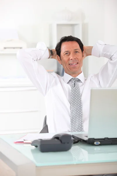 Relaxed businessman at desk — Stock Photo, Image