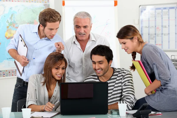 Students showing video to teacher on laptop computer — Stock Photo, Image