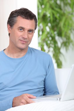 Man sat at table with computer clipart