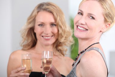 Two women with champagne flutes clipart