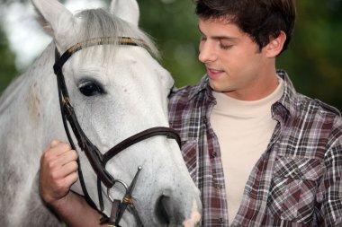 Young man with a horse clipart