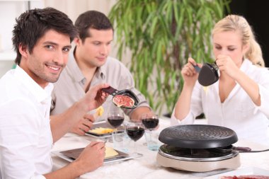 Friends eating raclette clipart