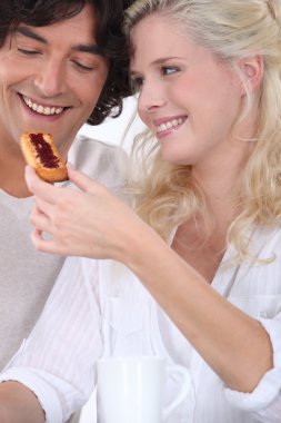 A wife give a tartine to her husband clipart