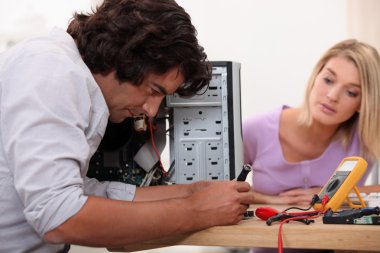 Man repairing his computer. clipart