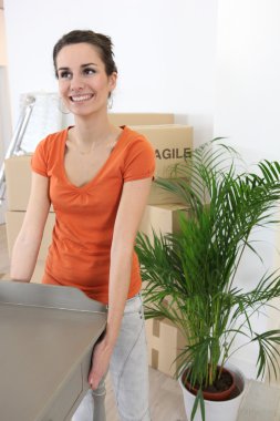 Woman carrying a table clipart