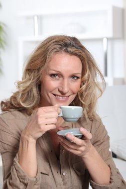 Woman drinking an expresso clipart