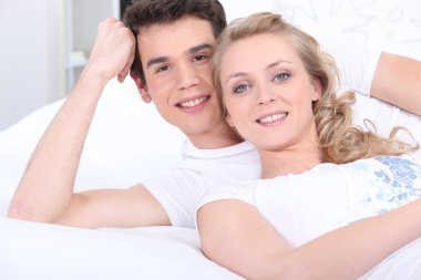 Portrait of a couple lying down clipart