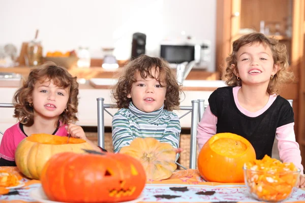 Three children with pumpkins — Stock Photo, Image