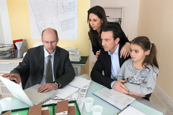 Family sitting in an architect's office — Stock Photo, Image