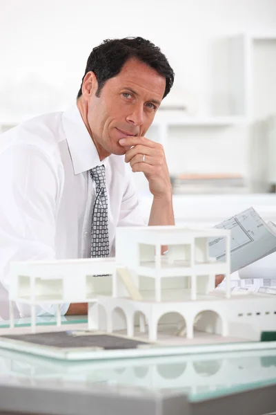 Architect with plans and 3D model — Stock Photo, Image