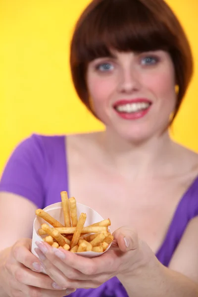 Giovane donna che propone patatine fritte — Foto Stock