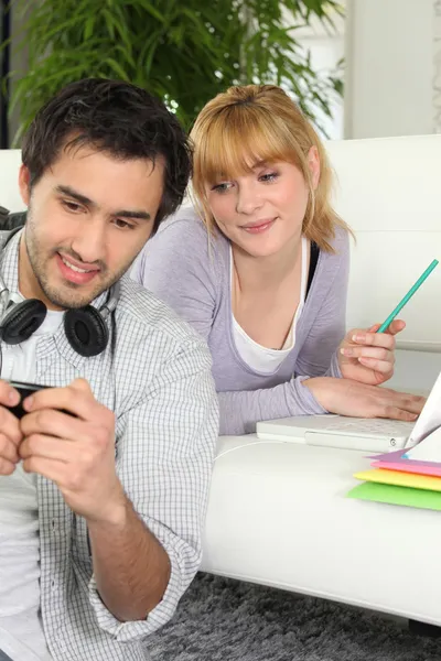 Young couple studying at home — Stock Photo, Image