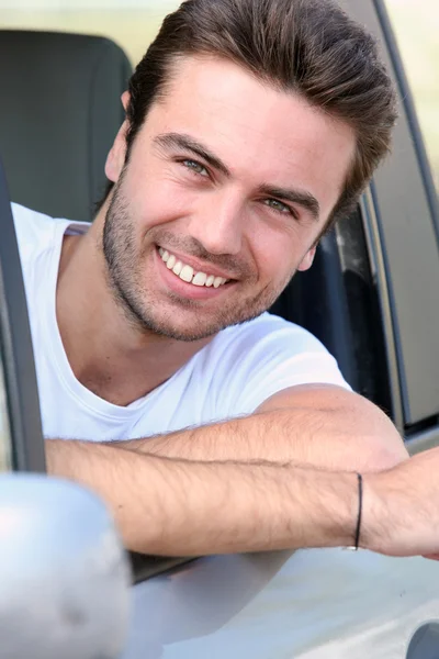 Young man sitting in the driving seat — Stock Photo, Image