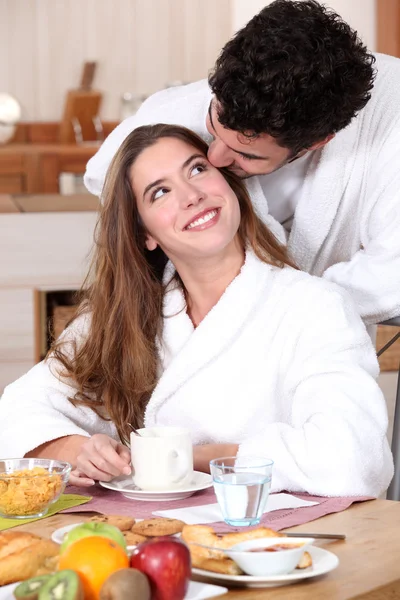 Couple wearing matching bathing robes in kitchen — Stock Photo, Image