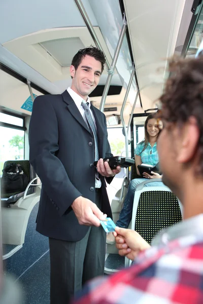 Iletken bir tramvay biletlerini kontrol gülümseyen — Stok fotoğraf