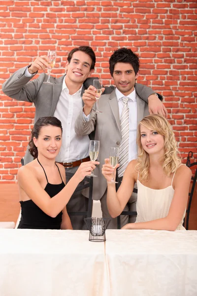 Couples celebrating in a restaurant — Stock Photo, Image