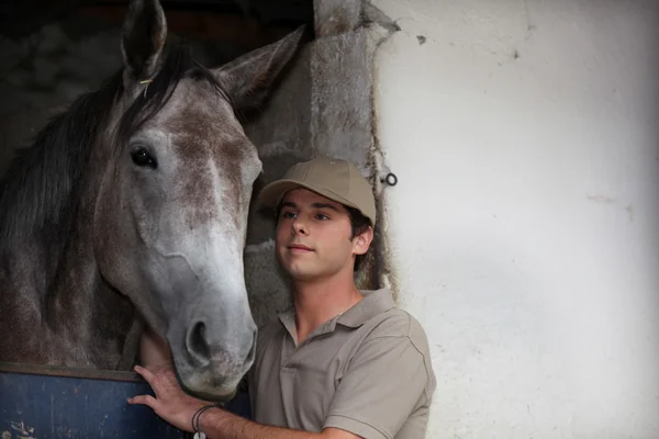 Menino cuidando de seu cavalo — Fotografia de Stock