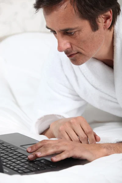 Man working in dressing gown. — Stock Photo, Image