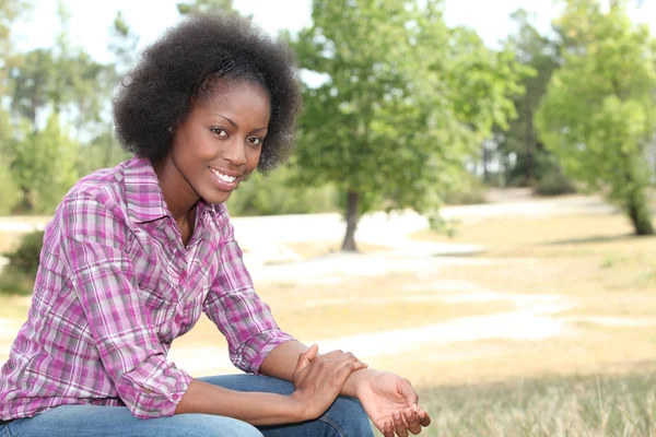 African woman relaxing in the park — Stock Photo, Image