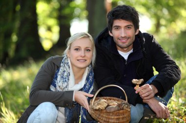 Couple picking mushrooms clipart