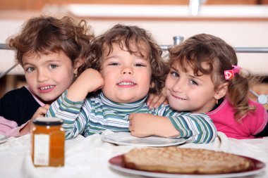 Three sisters enjoying crepes. clipart