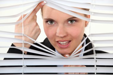 Young woman behind blinds clipart