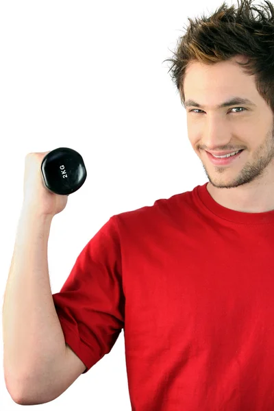 Young man with a 2kg dumbbell — Stock Photo, Image