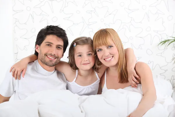 Parents in bed with child — Stock Photo, Image