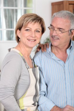 Middle-aged couple in kitchen clipart