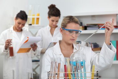 Women working in a scientific laboratory clipart