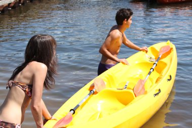 Young couple with boat clipart