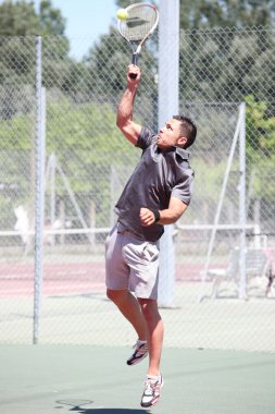 Man playing tennis clipart