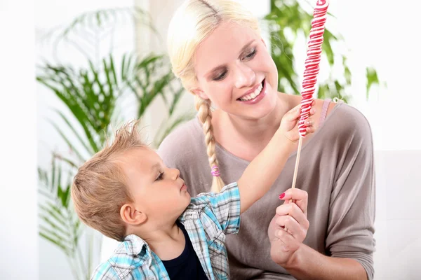 Gorgeous young mother offering her son lollipop — Stock Photo, Image