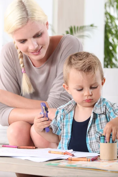 stock image Young boy coloring with wax crayons