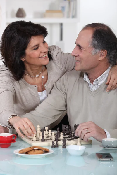 Loving couple playing chess together — Stock Photo, Image