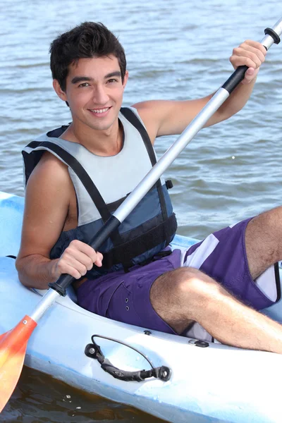 年轻人划着皮划艇 — 图库照片