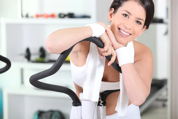 Young woman on an exercise machine — Stok fotoğraf