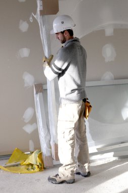 Man carrying sheet of plaster board clipart