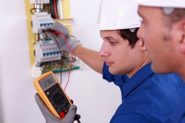 Two technical engineers checking electrical equipment clipart