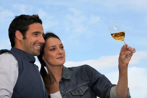 Couple looking at a glass of wine — Stock Photo, Image