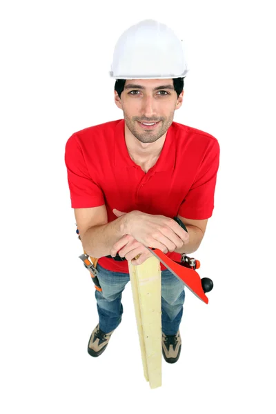 Craftsman holding a board and a rasp — Stock Photo, Image