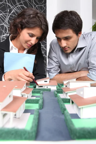 Colaboradores assistindo modelo imobiliário — Fotografia de Stock
