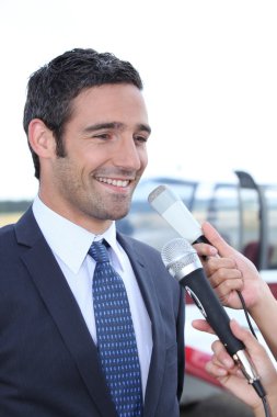 Man talking to reporters clipart