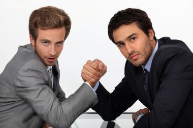 Two young men well dressed doing arm-wrest clipart